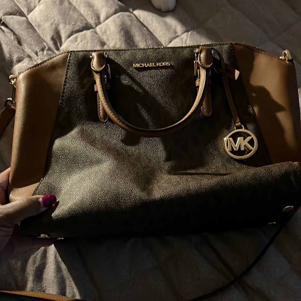 MK leather purse with feet on the bottom.